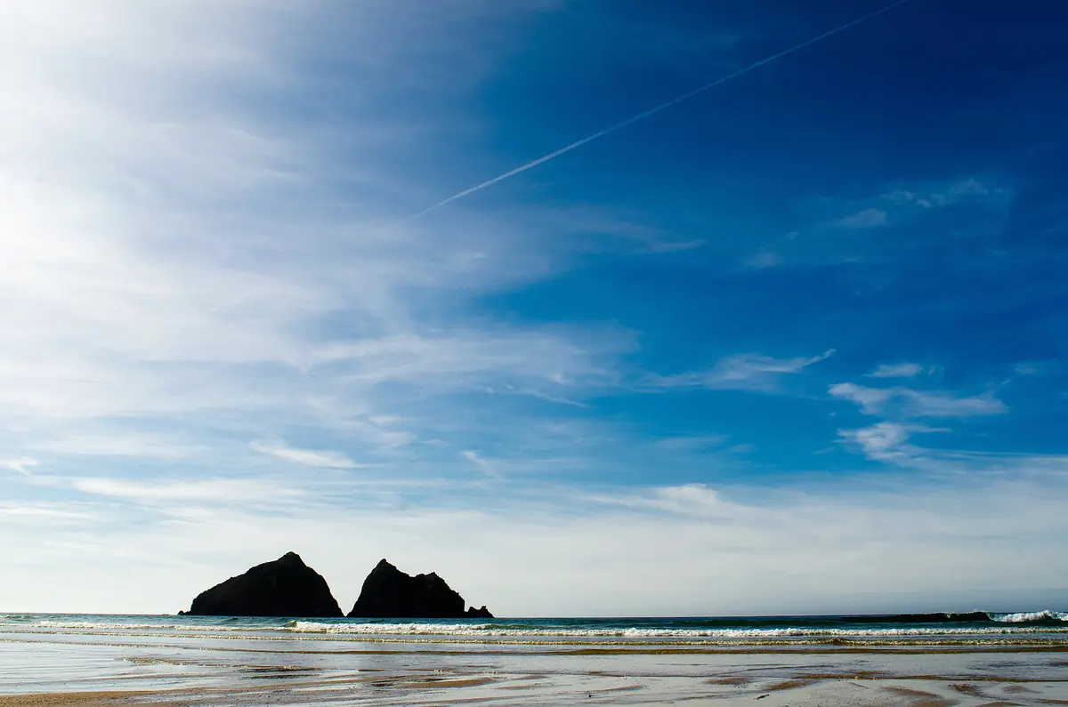 Gull Rocks silhouetted off Holywell Bay