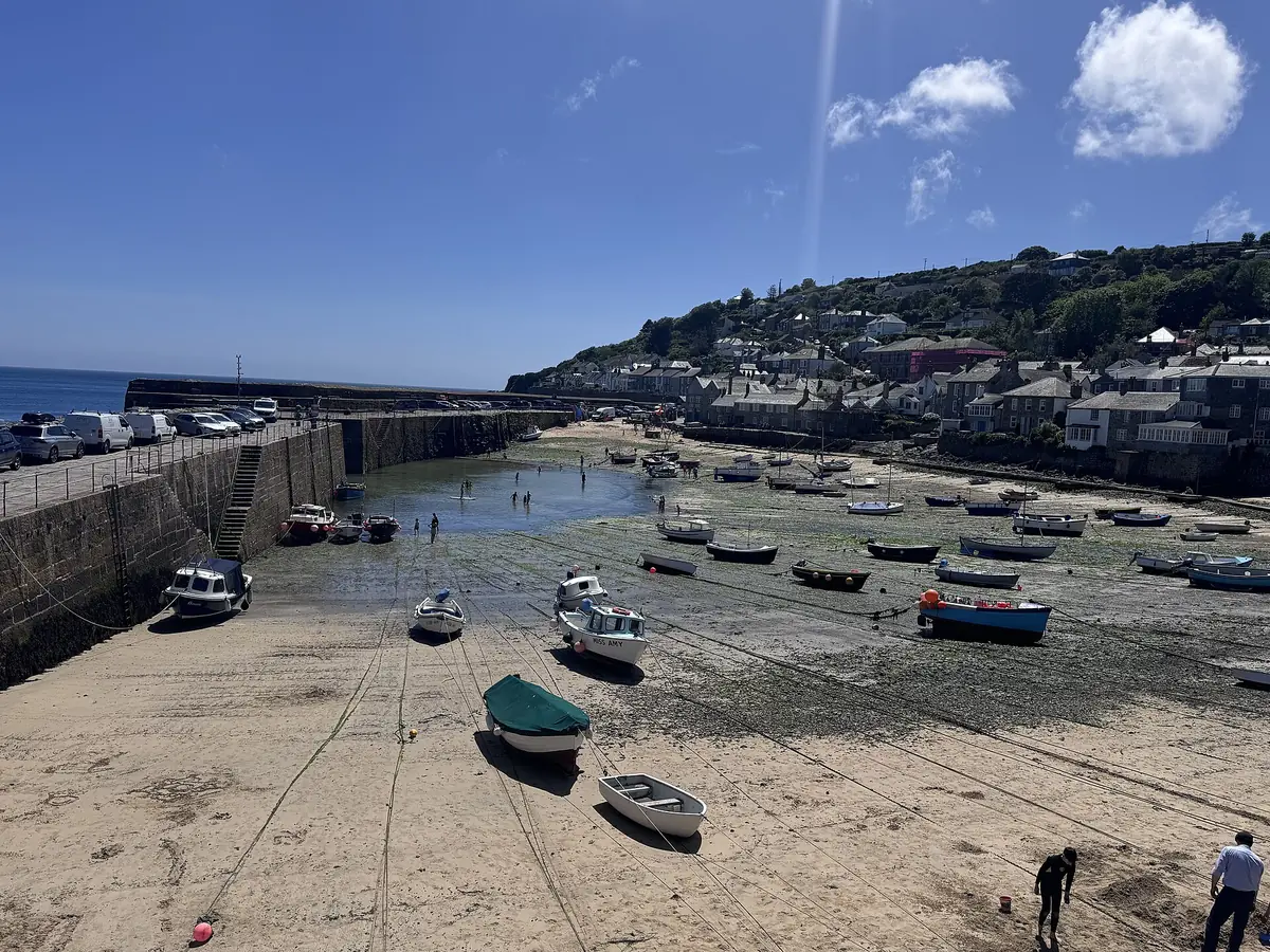 Boats resting on the sand in Mousehole harbour
