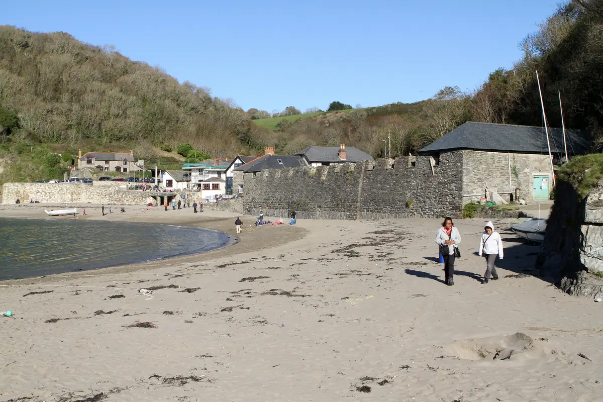 The small harbour wall and sandy cove at Polkerris